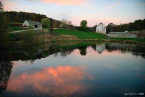 Barn, pond, sky at sunset