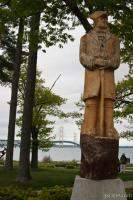 Wood statue of Alexander Henry, and Mackinac Bridge