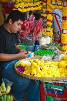 Street vendor making offerings for the temple