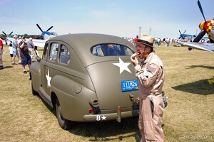 Donut eating pilot and old military vehicle