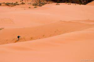 Photographer hiking the dunes