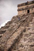 Worker climbing up the ruined side of El Castillo