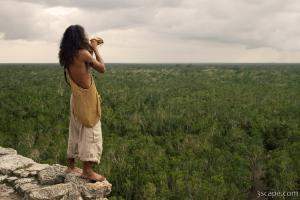 Local musician blowing a conch shell horn for really long time