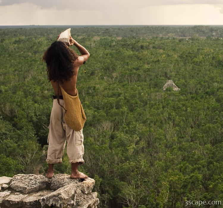 Local musician blowing a conch shell horn for really long time