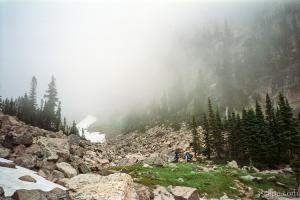 Hikers walking off into the mountain fog