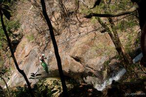 Rappelling down the cable over a waterfall