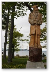 License: Wood statue of Alexander Henry, and Mackinac Bridge