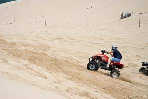 Quad ATV riding in dunes