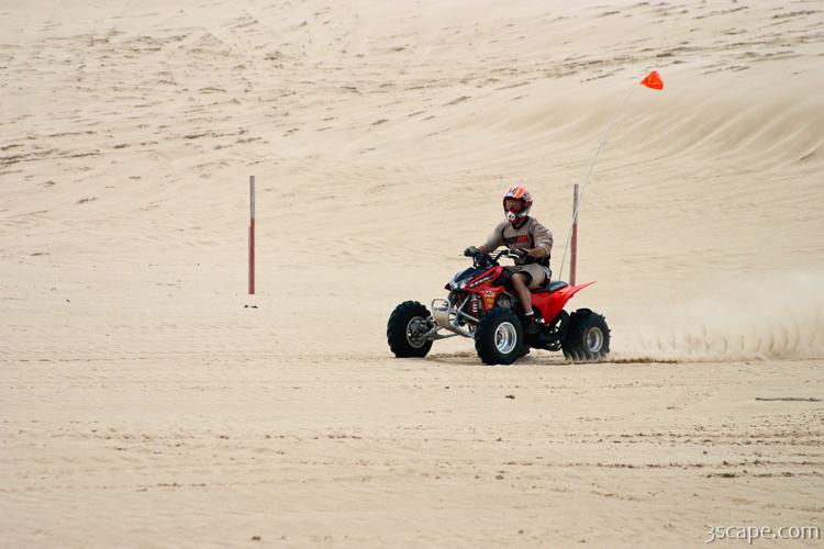 Quad ATV riding in dunes
