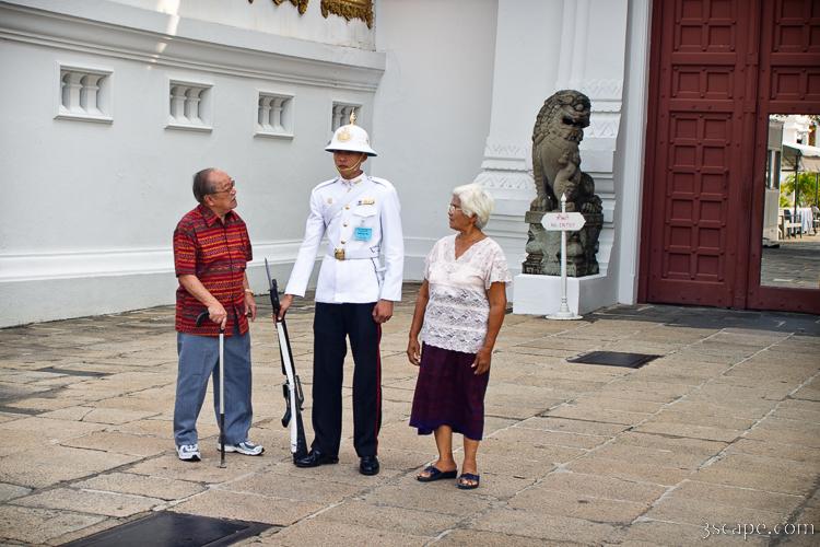 Tourists checking out a gate guard