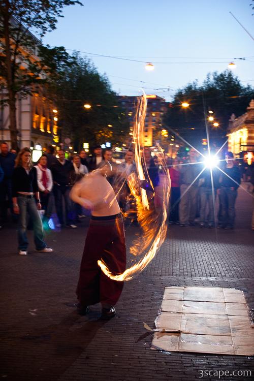 Street performer showing off fire ropes