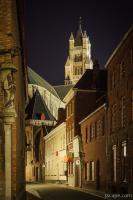 Narrow illuminated street and St Saviour Cathedral