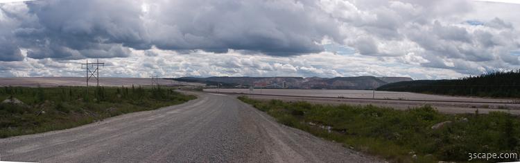 Panoramic view of iron mine, lake, and road