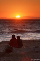 Two people enjoying the sunset at Tree at sunset, Leo Carrillo State Beach