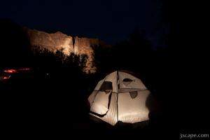 Night shot of camp site with illuminated canyon walls