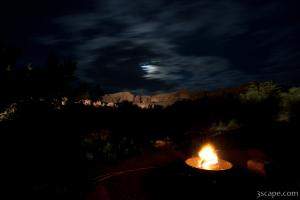 Night shot of camp site with illuminated canyon walls