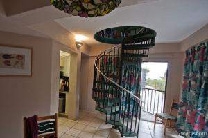 Interior of bungalo (condo) at Coco Plum Resort (spiral staircase)