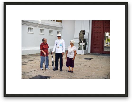 Tourists checking out a gate guard Framed Fine Art Print