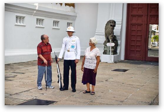 Tourists checking out a gate guard Fine Art Metal Print