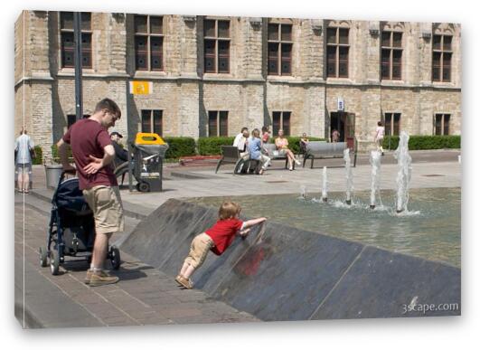 Little boy playing in the fountain Fine Art Canvas Print