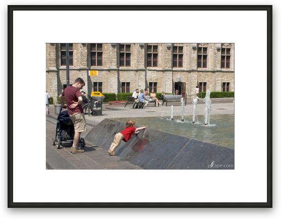 Little boy playing in the fountain Framed Fine Art Print