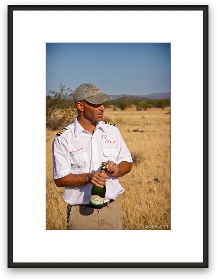Our balloon pilot opening the champagne Framed Fine Art Print
