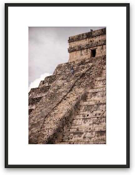 Worker climbing up the ruined side of El Castillo Framed Fine Art Print