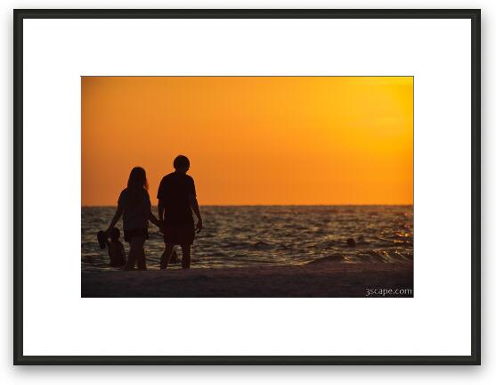 Couple taking a romantic walk on the beach Framed Fine Art Print