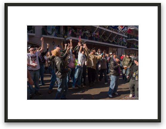 People on Bourbon Street trying to catch beads Framed Fine Art Print