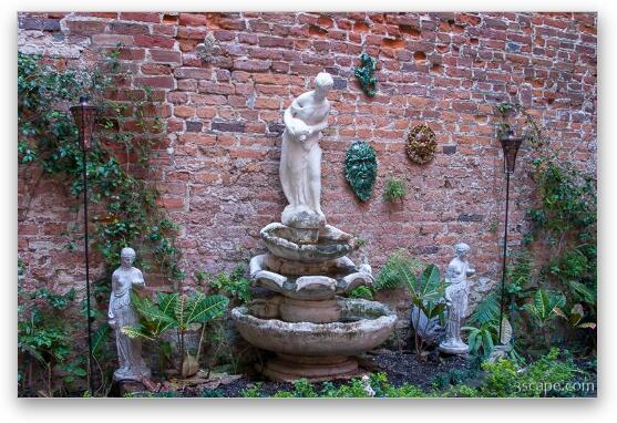 Fountain and sculptures tucked away in an alley Fine Art Metal Print