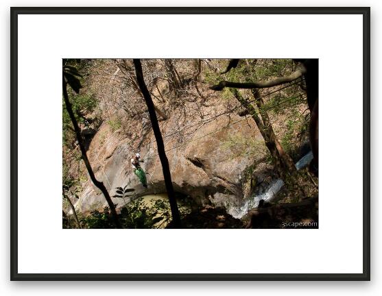 Rappelling down the cable over a waterfall Framed Fine Art Print
